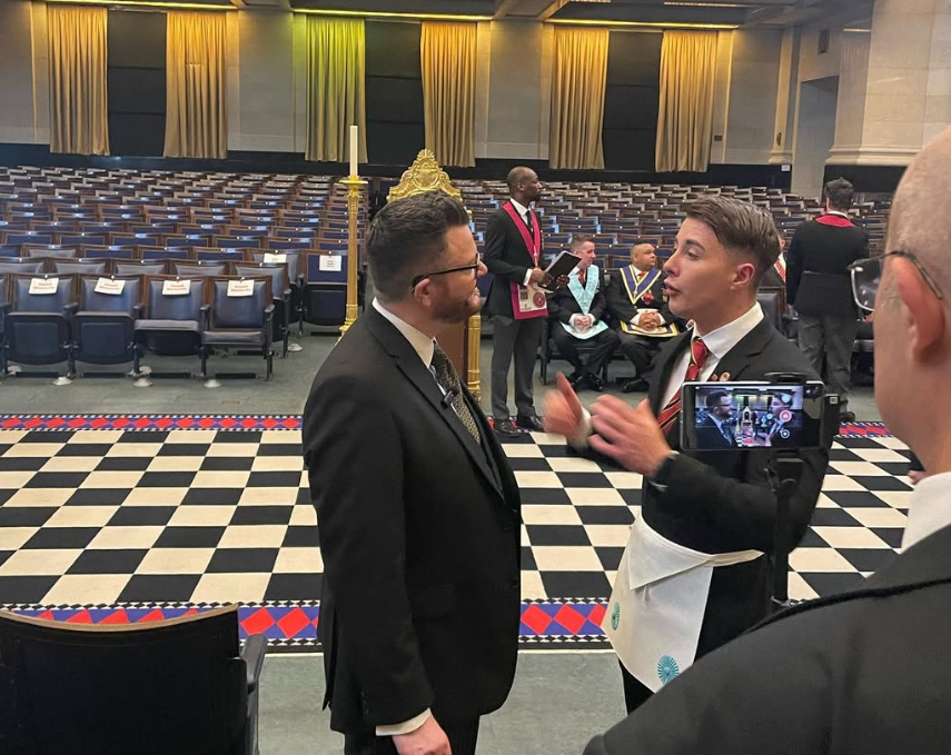 Members in conversation before a ceremony